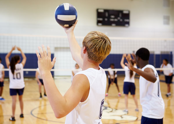 Boy practicing volleyball serves